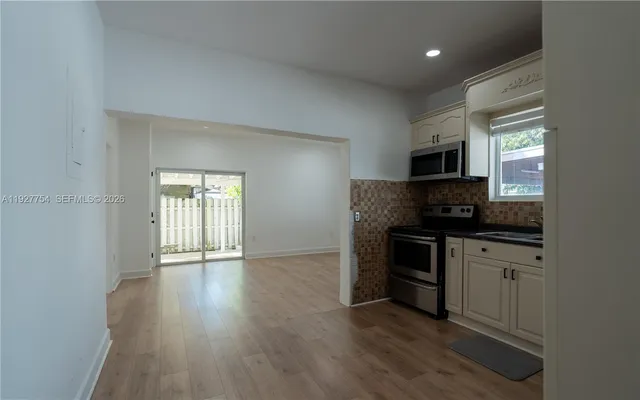 a kitchen with a sink and a stove top oven