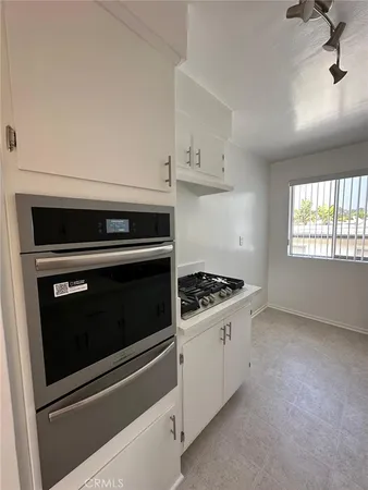 a stove top oven sitting inside of a kitchen
