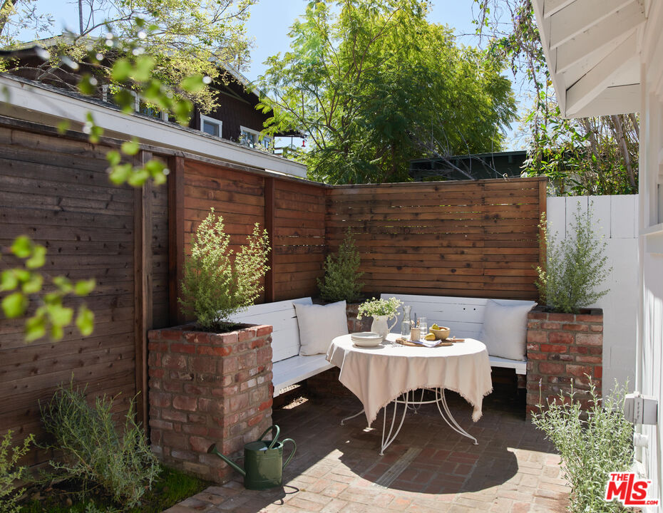 6506 Ruby Street Los Angeles, CA 90042 - Photo 17 of 21 a outdoor dining space with furniture and potted plants