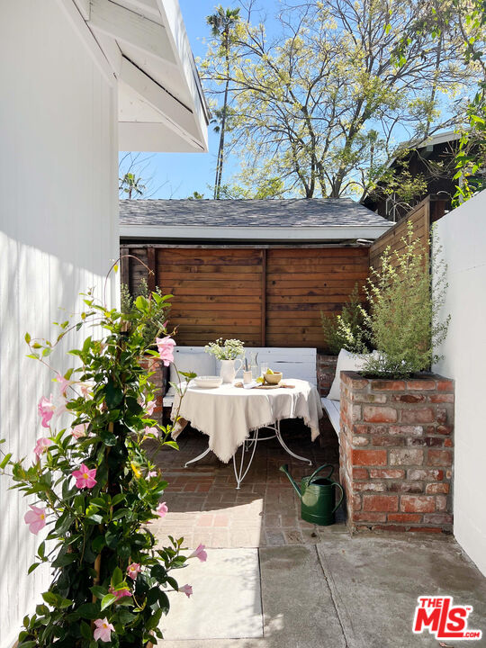 6506 Ruby Street Los Angeles, CA 90042 - Photo 20 of 21 a view of backyard with a table and chairs and potted plants