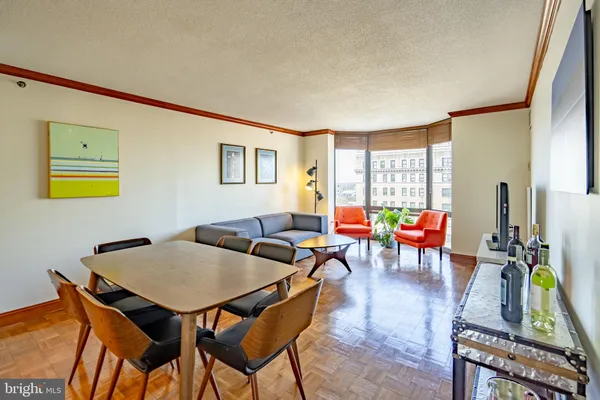 a living room with furniture a rug and a window