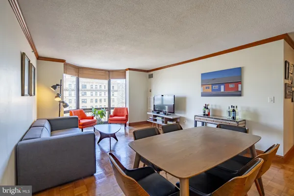 a living room with furniture a large window and a flat screen tv