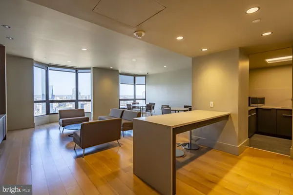a dining hall with stainless steel appliances granite countertop a stove and a refrigerator