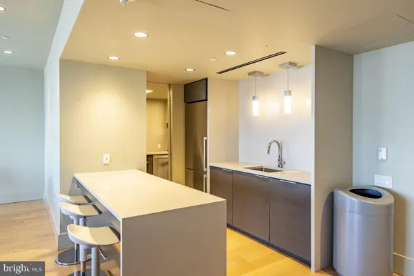 a kitchen with stainless steel appliances kitchen island sink refrigerator and stove