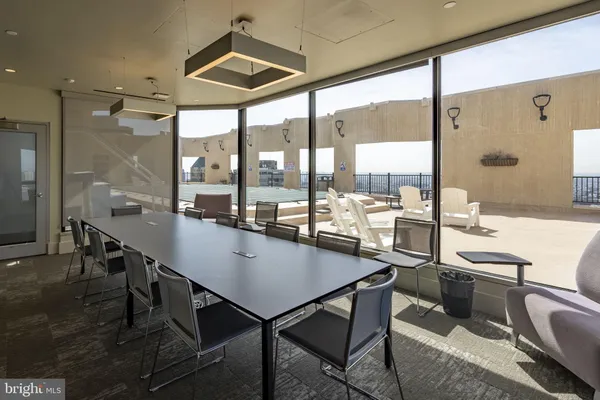 a kitchen with a table chairs stove and kitchen view