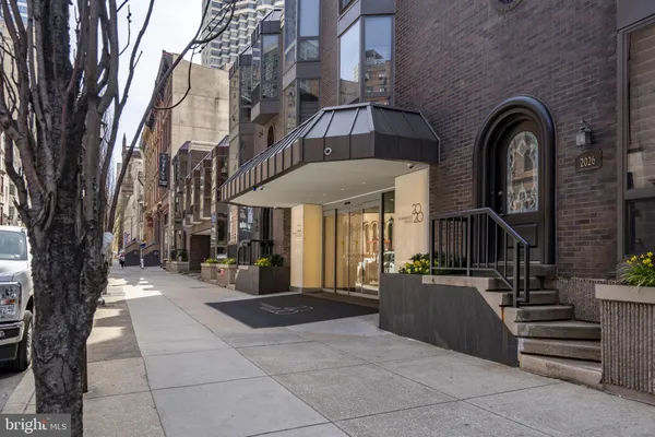 a view of a building with a bench in front of building