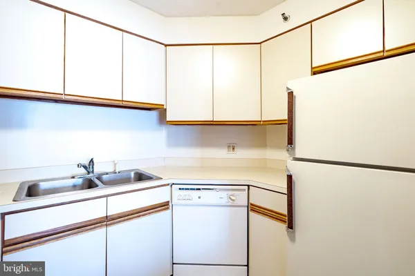a kitchen with a sink and a refrigerator