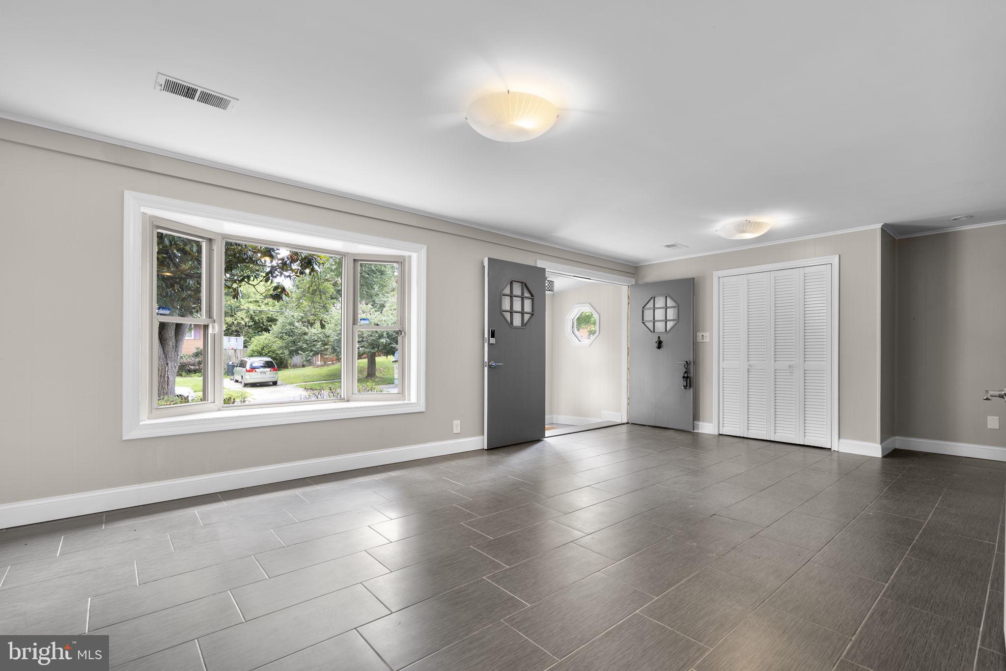 822 Loxford Terrace Silver Spring, MD 20901 - Photo 45 of 61 wooden floor in an empty room with a window