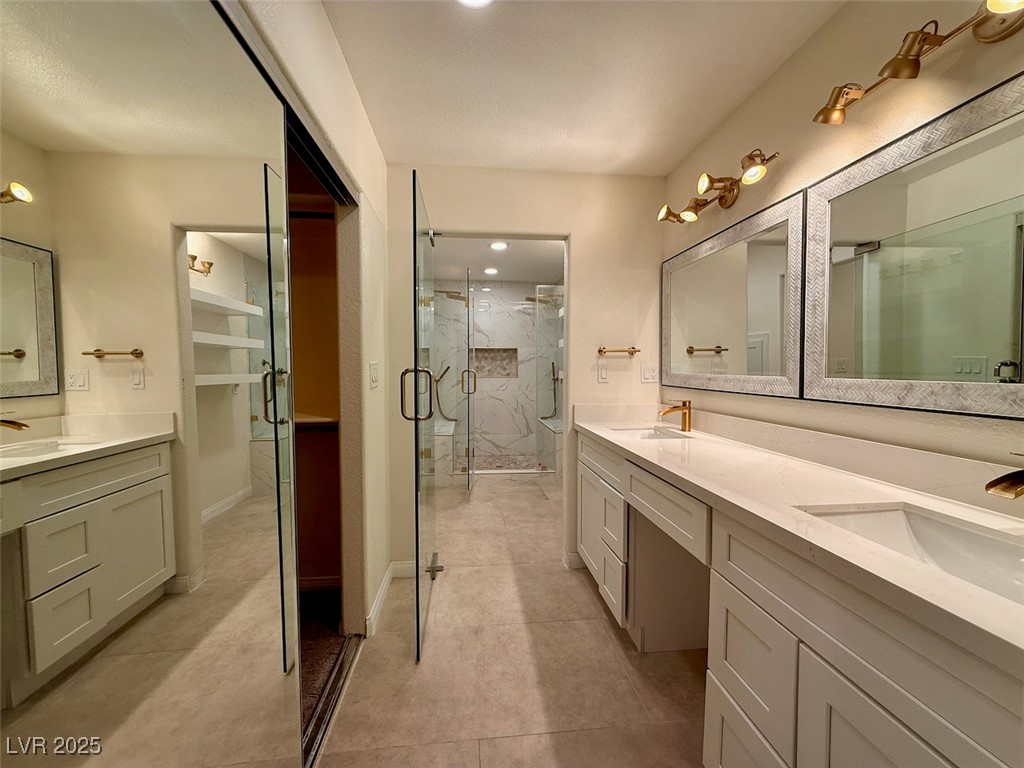 4969 Jeremy Drive Las Vegas, NV 89113 - Photo 28 of 73 Full bathroom featuring double vanity, a marble finish shower, and recessed lighting