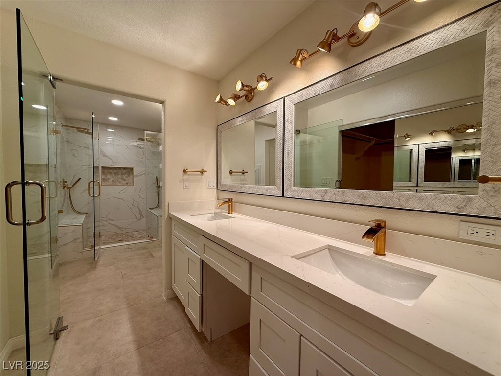 4969 Jeremy Drive Las Vegas, NV 89113 - Photo 29 of 73 Bathroom featuring double vanity, a marble finish shower, and recessed lighting