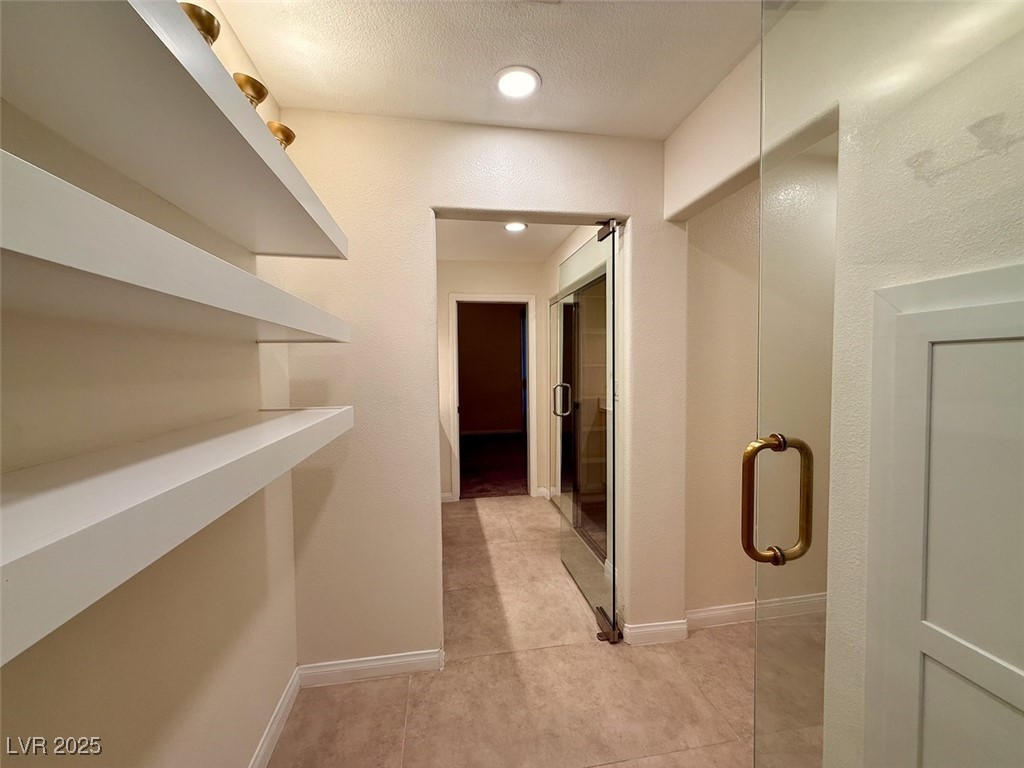 4969 Jeremy Drive Las Vegas, NV 89113 - Photo 34 of 73 Hallway featuring a textured ceiling and baseboards