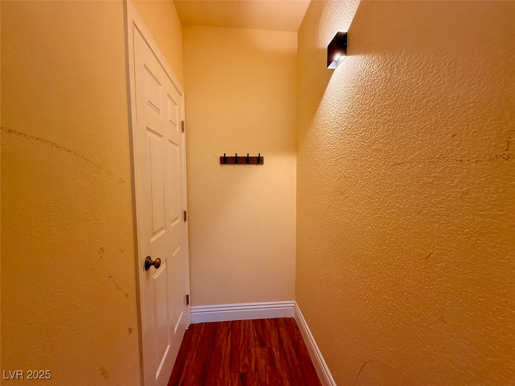 4969 Jeremy Drive Las Vegas, NV 89113 - Photo 35 of 73 Corridor with a textured wall and dark wood-type flooring