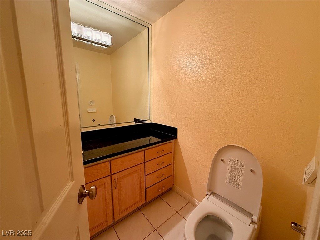 4969 Jeremy Drive Las Vegas, NV 89113 - Photo 42 of 73 Half bath featuring light tile patterned flooring, vanity, and a textured wall