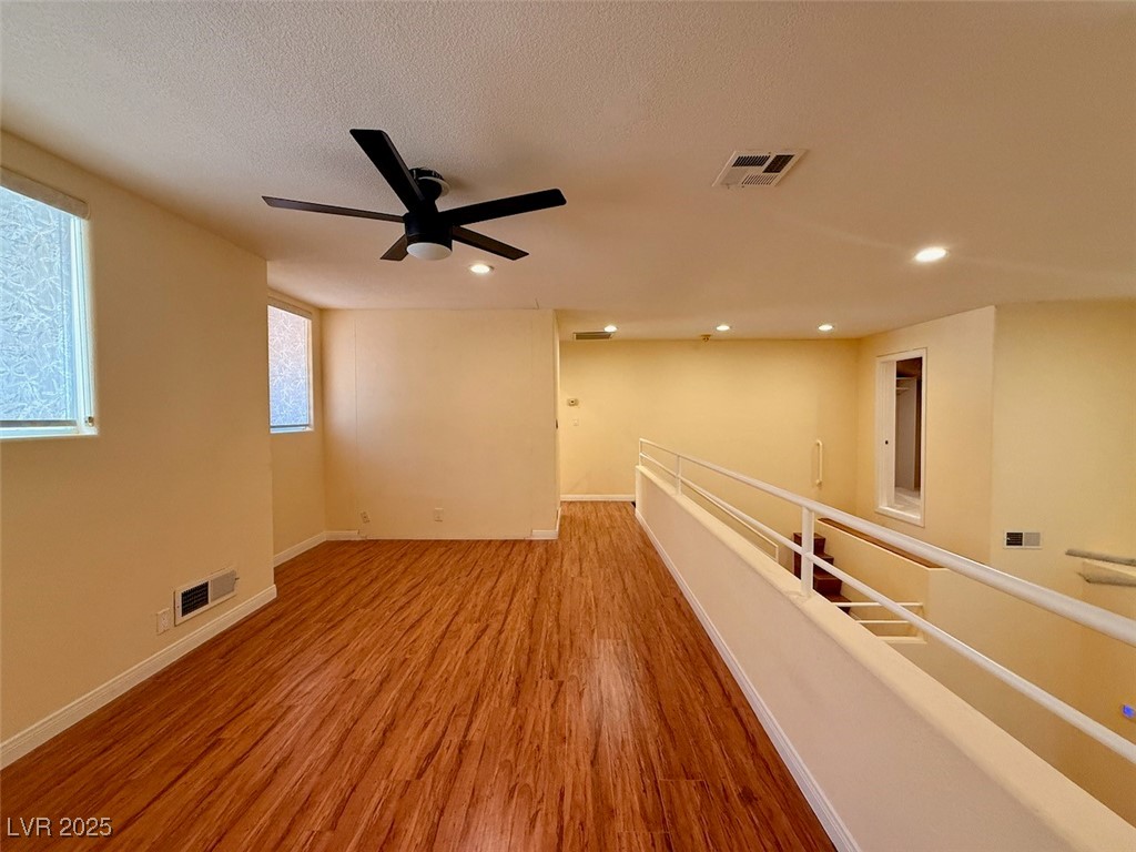 4969 Jeremy Drive Las Vegas, NV 89113 - Photo 46 of 73 Spare room featuring light wood-type flooring, ceiling fan, a textured ceiling, and recessed lighting