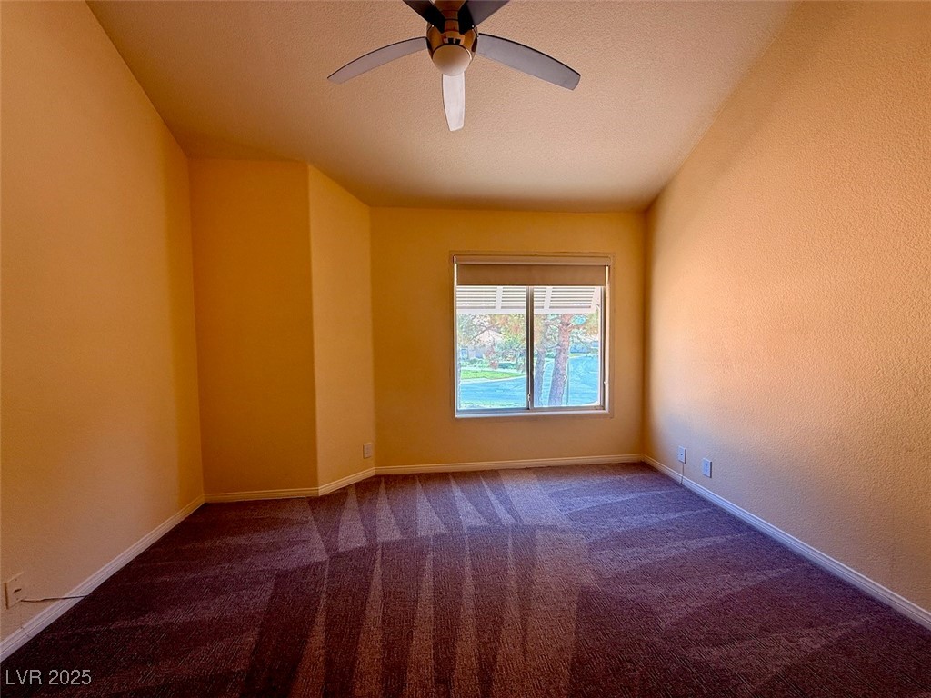 4969 Jeremy Drive Las Vegas, NV 89113 - Photo 49 of 73 Unfurnished room with dark colored carpet, a ceiling fan, and a textured ceiling
