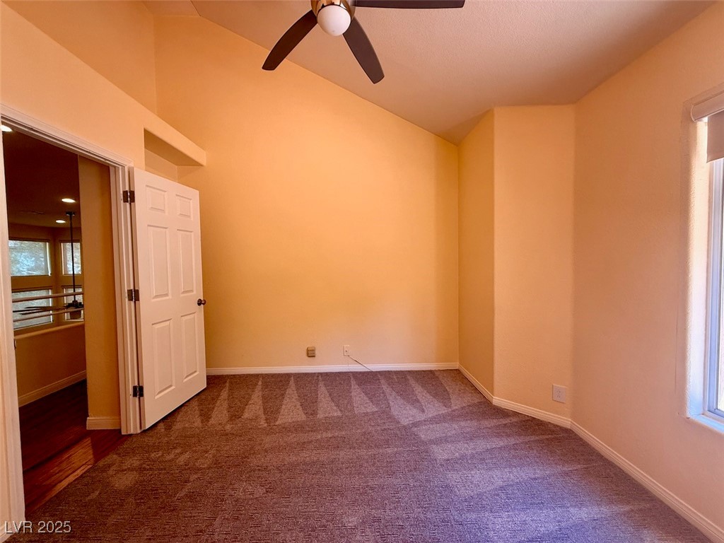 4969 Jeremy Drive Las Vegas, NV 89113 - Photo 51 of 73 Spare room with dark colored carpet, a ceiling fan, and high vaulted ceiling
