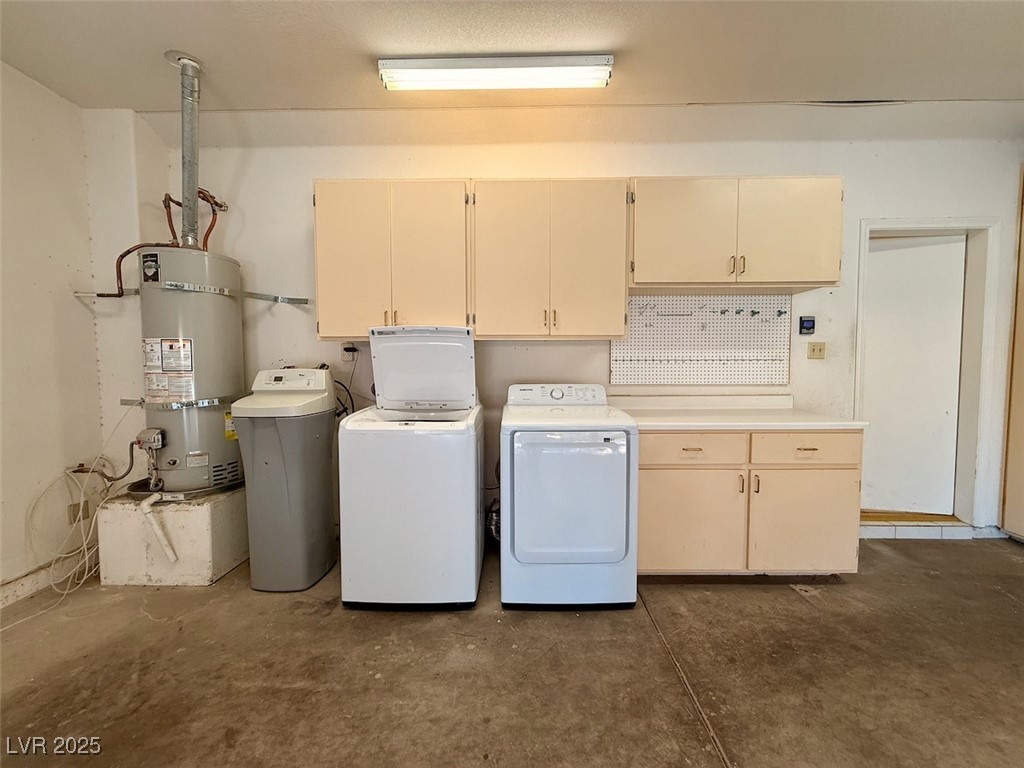 4969 Jeremy Drive Las Vegas, NV 89113 - Photo 70 of 73 Laundry room featuring cabinet space, concrete flooring, washing machine and dryer, and water heater