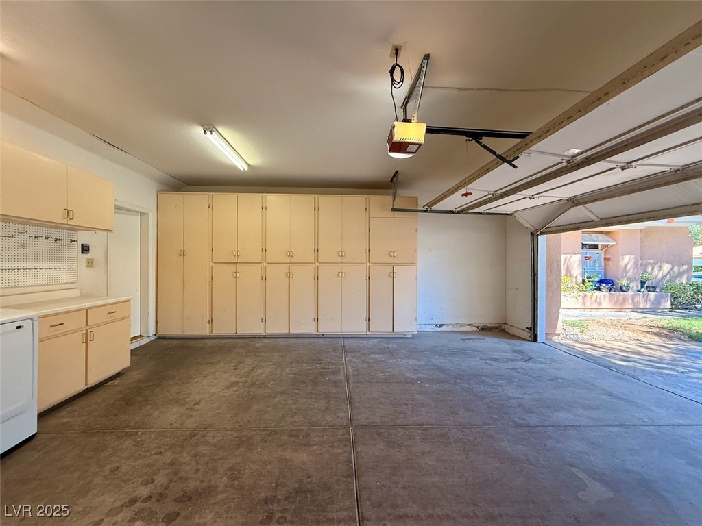 4969 Jeremy Drive Las Vegas, NV 89113 - Photo 71 of 73 Garage featuring washer / clothes dryer and a garage door opener