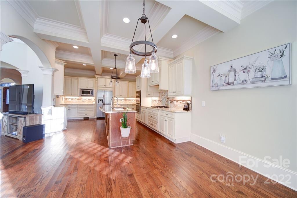 174 Birdie Drive Stanley, NC 28164 - Photo 13 of 46 a large kitchen with a lot of counter space and a wooden floor
