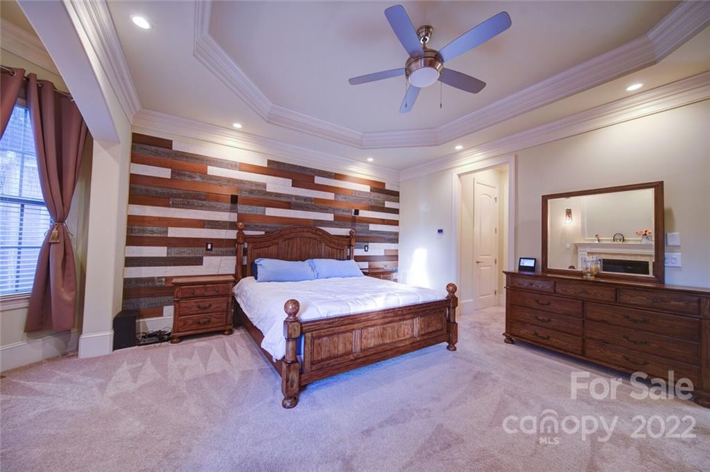 174 Birdie Drive Stanley, NC 28164 - Photo 20 of 46 a bedroom with a bed and a chandelier