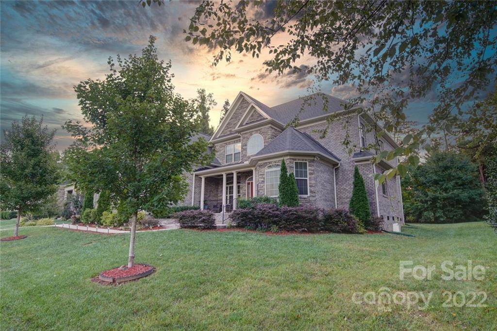 174 Birdie Drive Stanley, NC 28164 - Photo 2 of 46 a house view with a garden