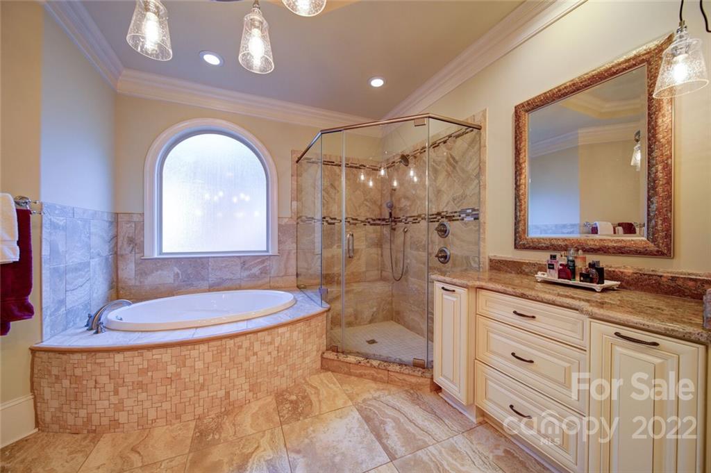 174 Birdie Drive Stanley, NC 28164 - Photo 21 of 46 a bathroom with a granite countertop sink a mirror and a shower