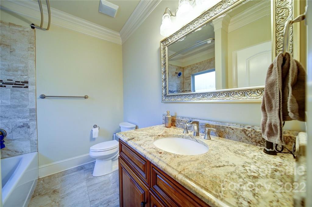 174 Birdie Drive Stanley, NC 28164 - Photo 26 of 46 a bathroom with a granite countertop sink toilet and a mirror