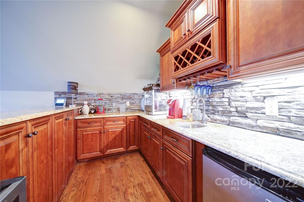 174 Birdie Drive Stanley, NC 28164 - Photo 30 of 46 a kitchen with stainless steel appliances granite countertop a sink and cabinets
