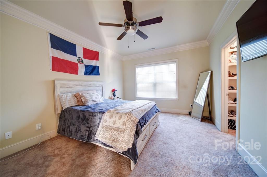 174 Birdie Drive Stanley, NC 28164 - Photo 32 of 46 a bedroom with a bed and a flat screen tv