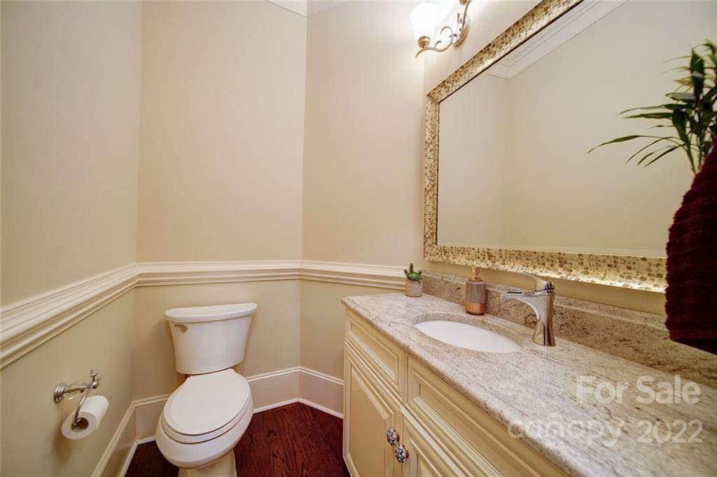 174 Birdie Drive Stanley, NC 28164 - Photo 39 of 46 a bathroom with a granite countertop sink mirror vanity and toilet