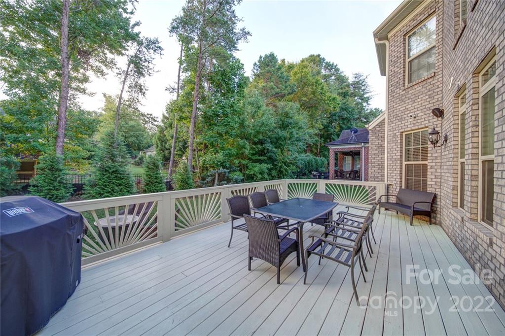 174 Birdie Drive Stanley, NC 28164 - Photo 41 of 46 a balcony with wooden floor table and chairs