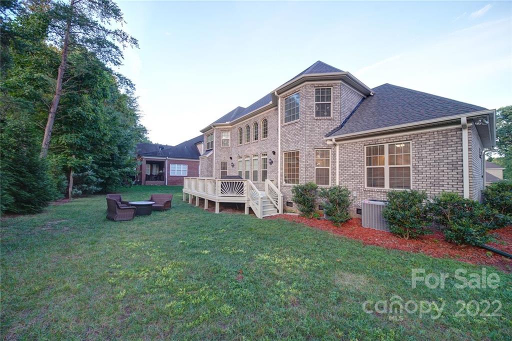 174 Birdie Drive Stanley, NC 28164 - Photo 45 of 46 a front view of a house with a garden and plants