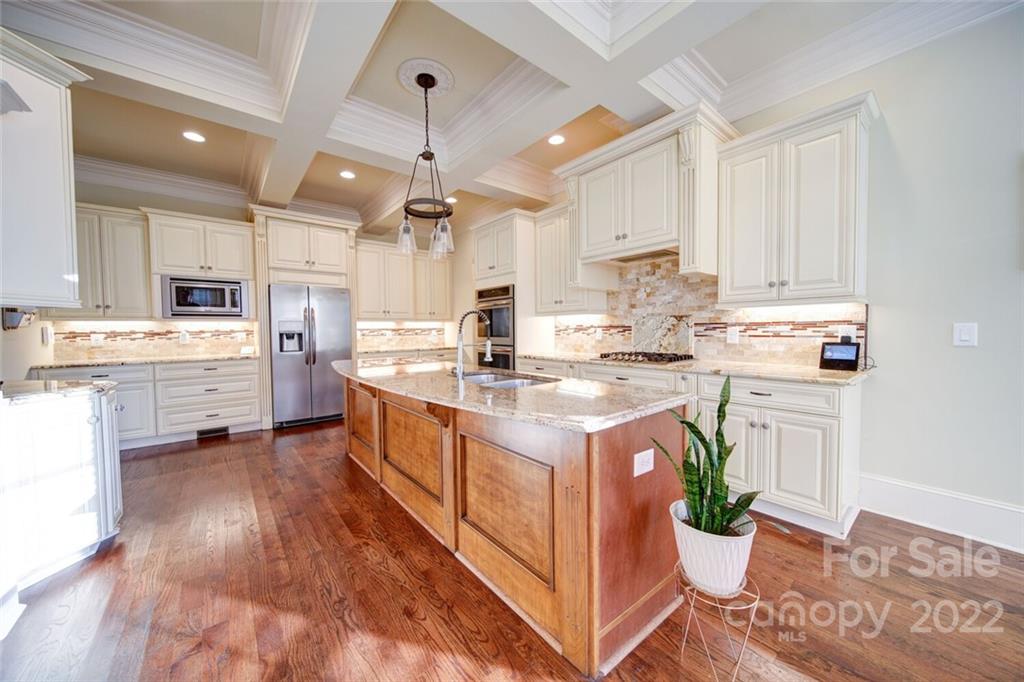 174 Birdie Drive Stanley, NC 28164 - Photo 9 of 46 a kitchen with stainless steel appliances granite countertop a stove top oven a sink dishwasher and a refrigerator