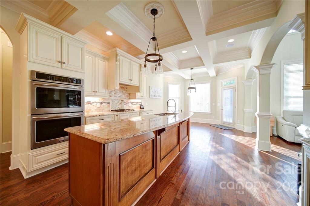 174 Birdie Drive Stanley, NC 28164 - Photo 10 of 46 a kitchen with stainless steel appliances kitchen island granite countertop a stove a sink and a refrigerator