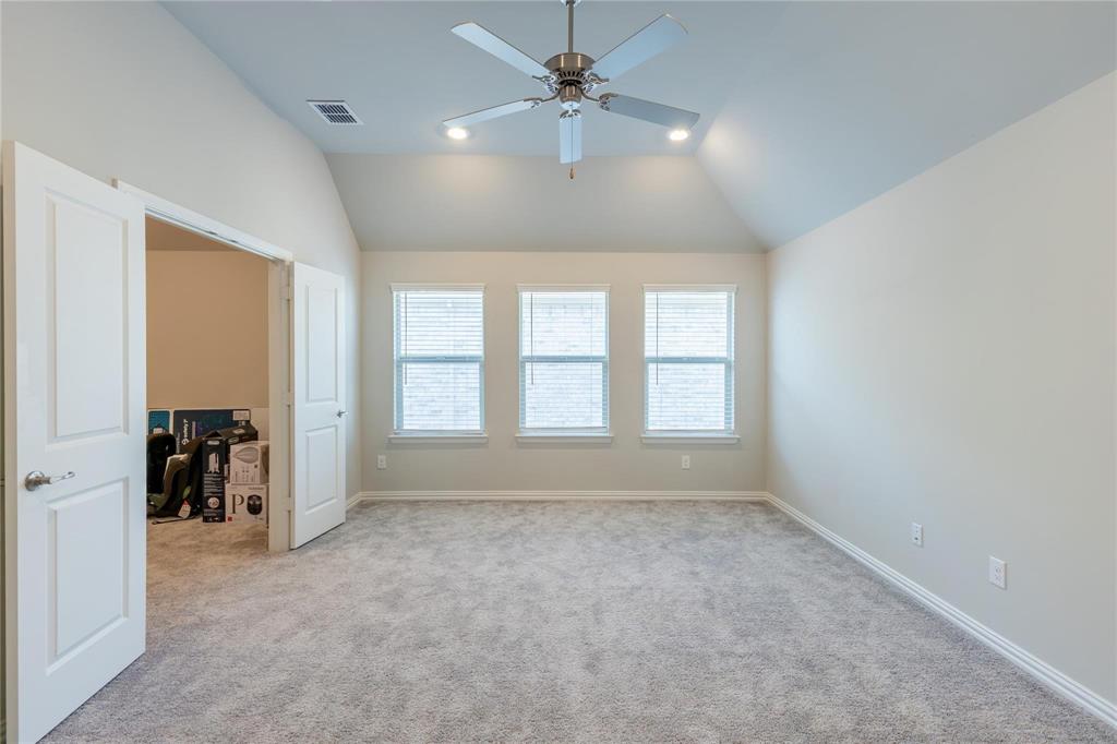 3920 Bentgrass Road Plano, TX 75023 - Photo 25 of 30 an empty room with chandelier fan and windows