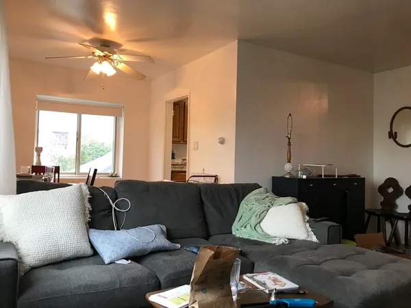a living room with furniture and a large mirror