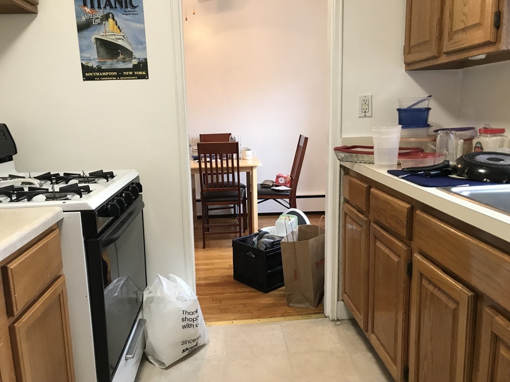 76 Euston Road, Unit 10 Boston, MA 02135 - Photo 7 of 11 a kitchen with a stove and a refrigerator