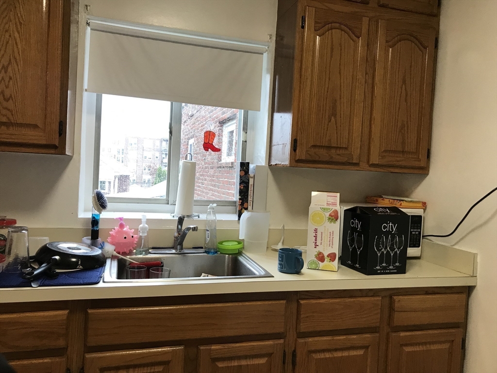 76 Euston Road, Unit 10 Boston, MA 02135 - Photo 8 of 11 a kitchen with a sink and cabinets