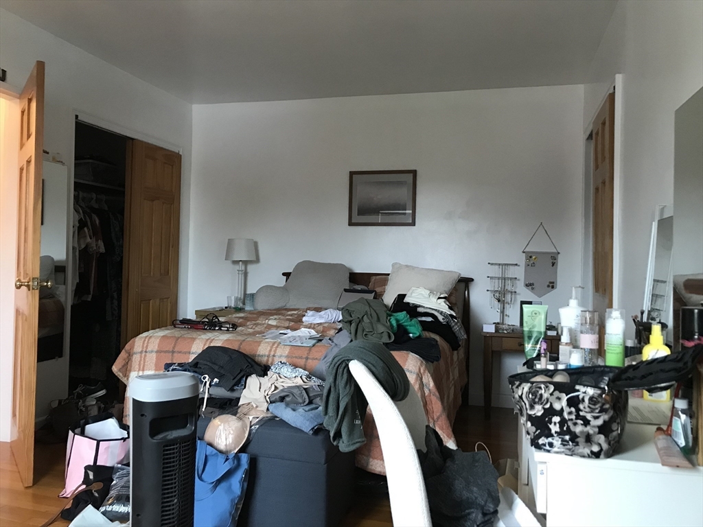 76 Euston Road, Unit 10 Boston, MA 02135 - Photo 9 of 11 a bed room with furniture and a potted plant