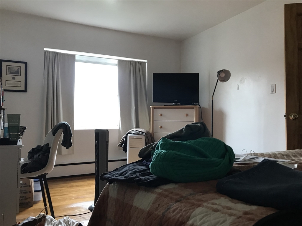 76 Euston Road, Unit 10 Boston, MA 02135 - Photo 10 of 11 a living room with furniture and a flat screen tv