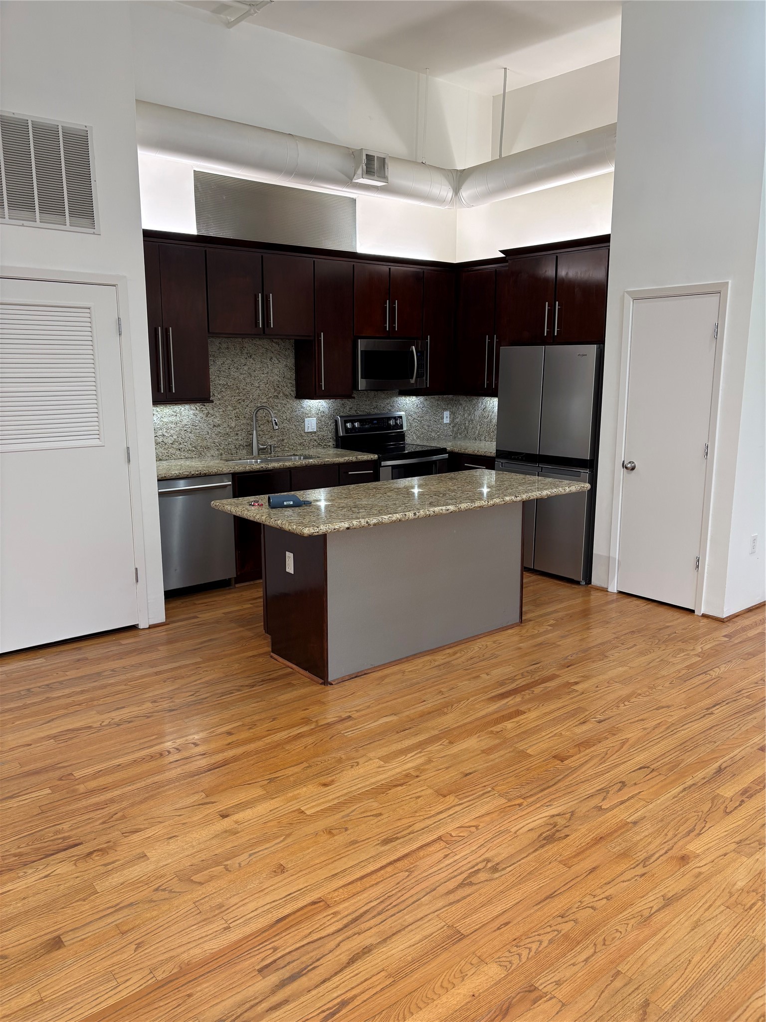 705 Main Street, Unit 205 Houston, TX 77002 - Photo 3 of 6 a kitchen with stainless steel appliances a sink and a stove top oven