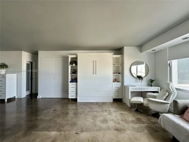 a living room with furniture a lamp and a table