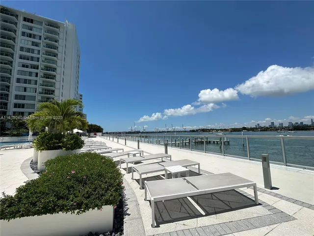 a view of roof deck with two chairs and a table