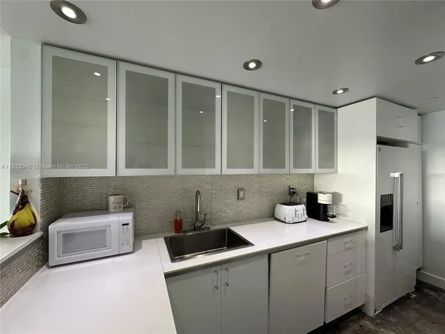 a kitchen with a sink cabinets and window