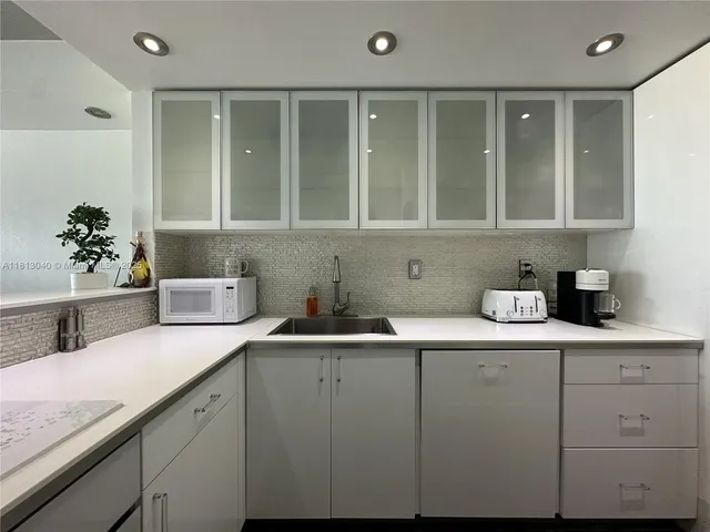 a kitchen with a sink and cabinets