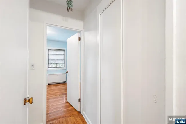 a view of a hallway with wooden floor