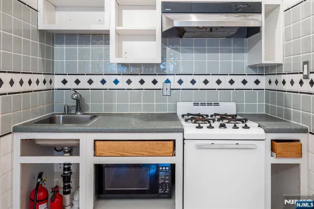 a kitchen with a stove and cabinets