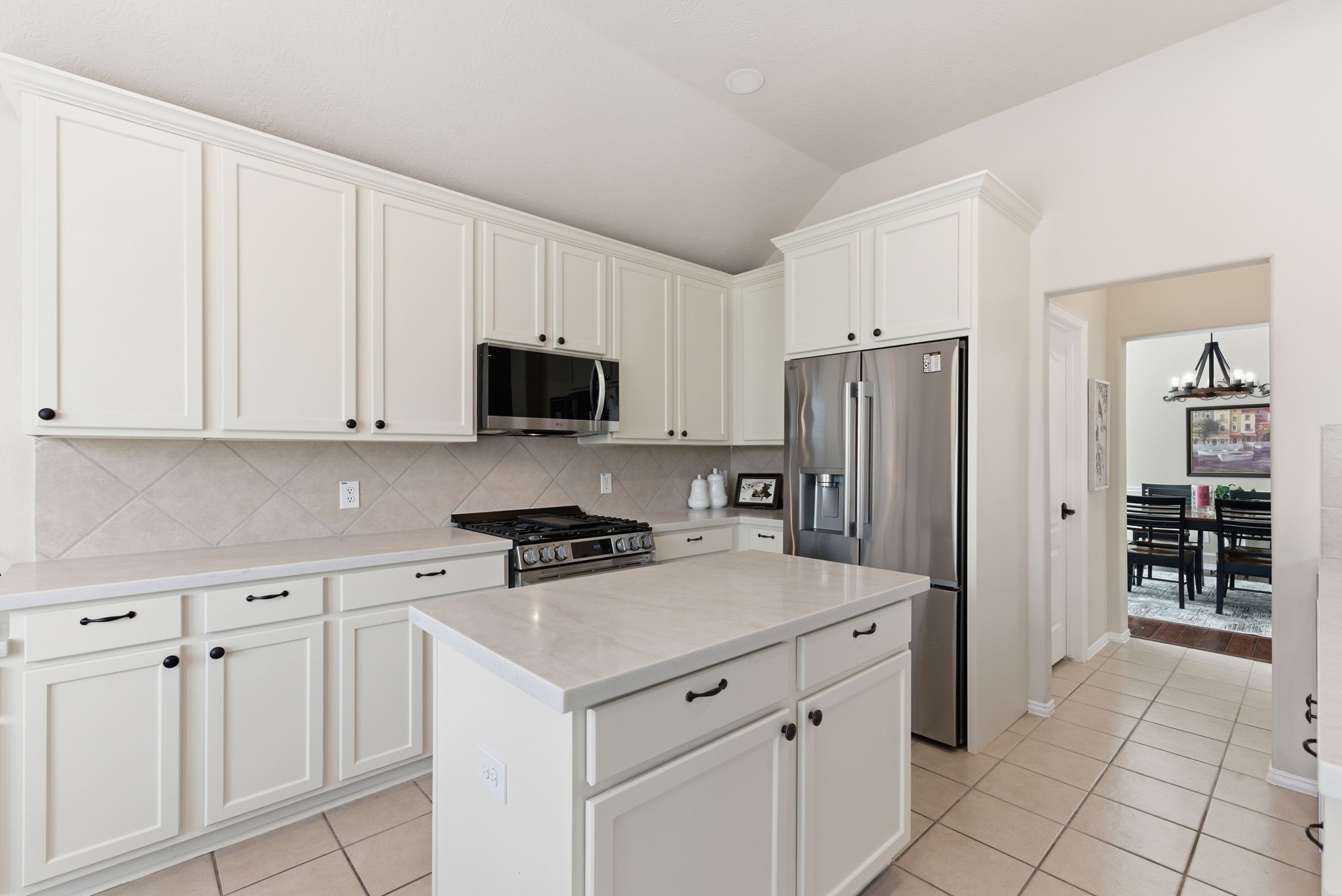 29814 Legends Pass Lane Spring, TX 77386 - Photo 19 of 46 a kitchen with white cabinets and refrigerator
