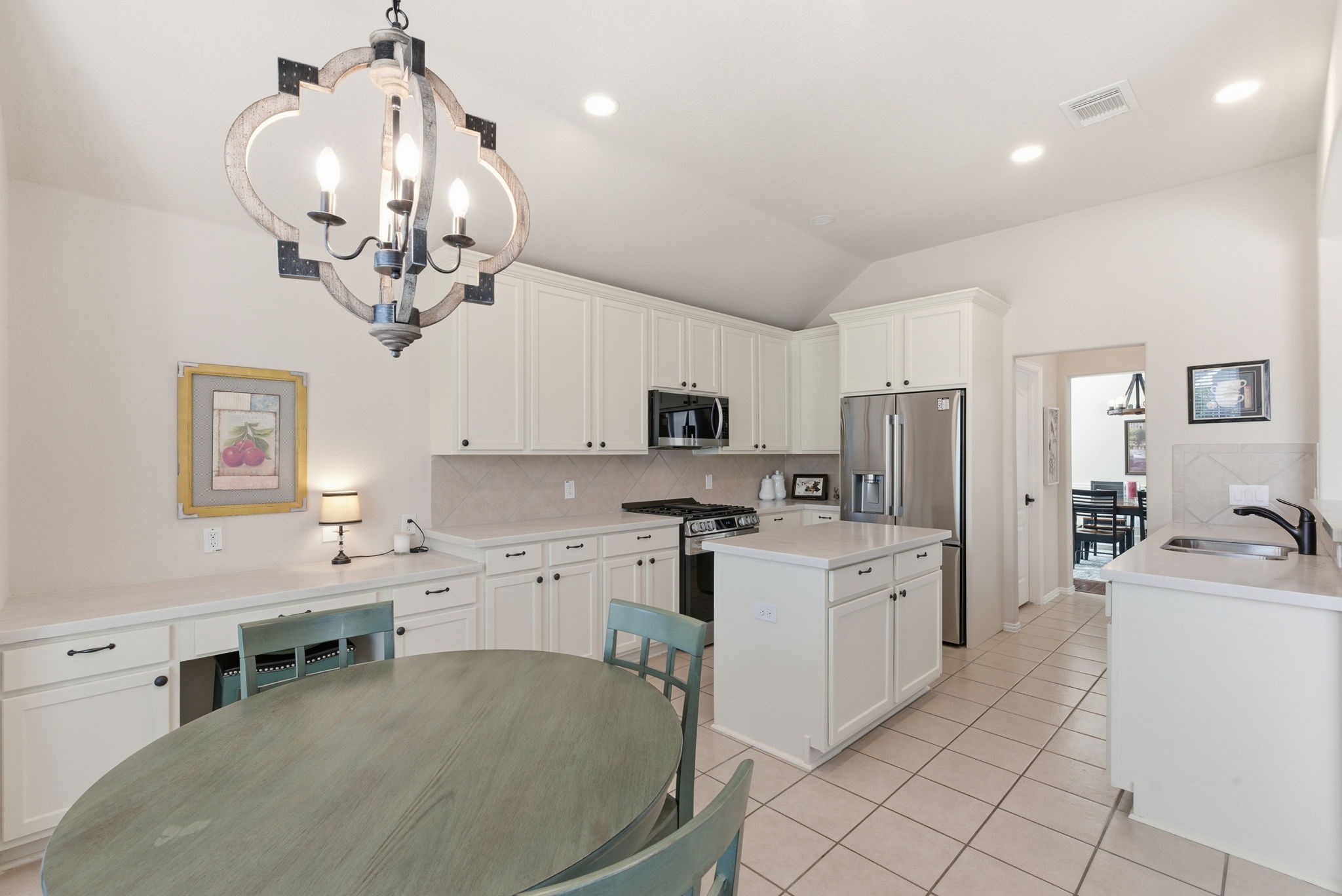 29814 Legends Pass Lane Spring, TX 77386 - Photo 21 of 46 a kitchen with stainless steel appliances a stove refrigerator sink and microwave