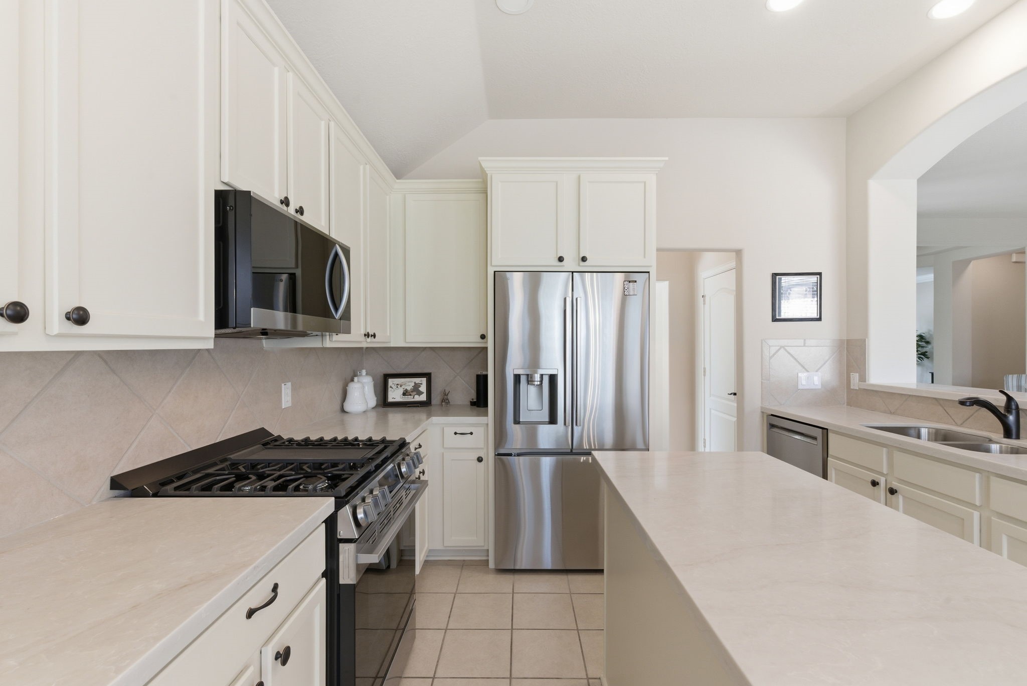 29814 Legends Pass Lane Spring, TX 77386 - Photo 22 of 46 a kitchen with a stove a sink and a refrigerator